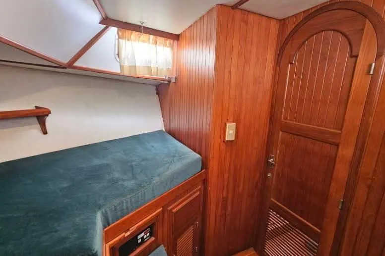 Slide: The Image of Cozy wooden cabin interior of 1988 Overseas Monk 42 yacht with bed and arched door. - 63