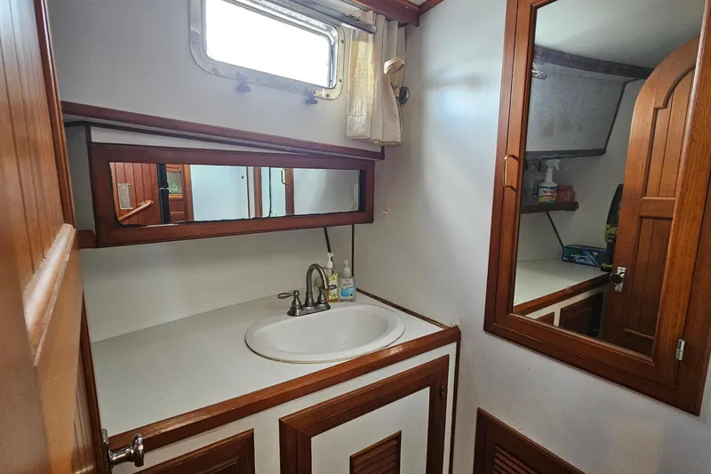 Slide: The Image of Bathroom interior of 1988 Overseas Monk 42 yacht with wooden cabinetry and sink. - 65