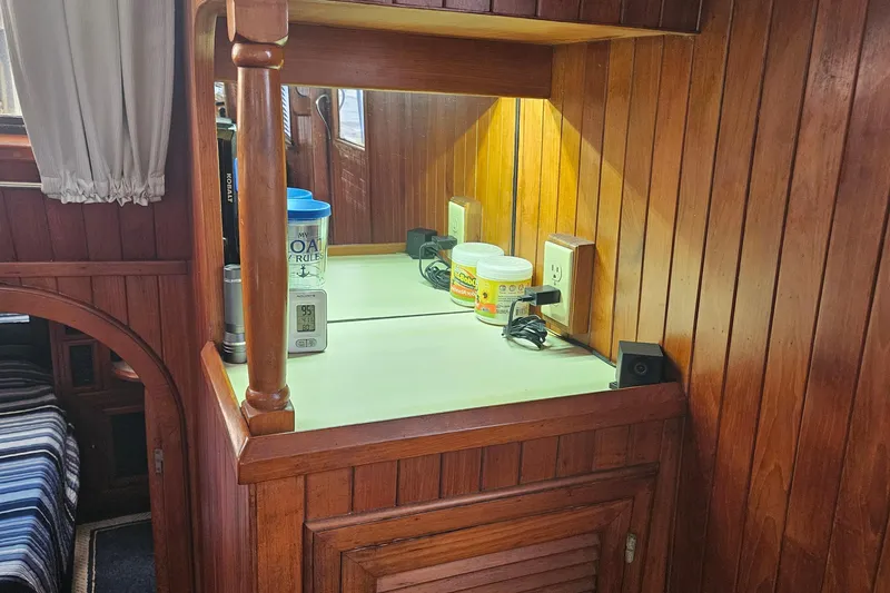 Slide: The Image of Wood-paneled interior of 1988 Overseas Monk 42 boat with countertop and storage. - 75