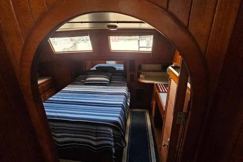 Slide: The Image of Interior of 1988 Overseas Monk 42 yacht with wooden paneling and seating area. - 76
