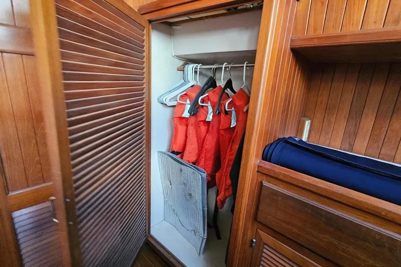 Slide: The Image of Cozy cabin interior of 1988 Overseas Monk 42 yacht with striped bedding and wooden furnishings. - 83