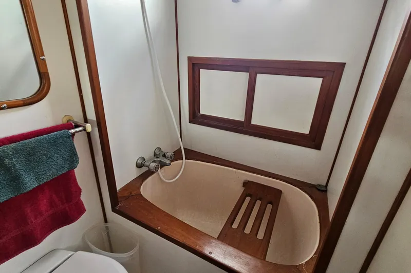 Slide: The Image of Bathroom interior of 1988 Overseas Monk 42 yacht with sink, toilet, and shower. - 86