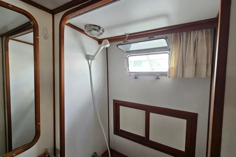 Slide: The Image of Bathroom interior of 1988 Overseas Monk 42 yacht with sink, mirror, and towels. - 87