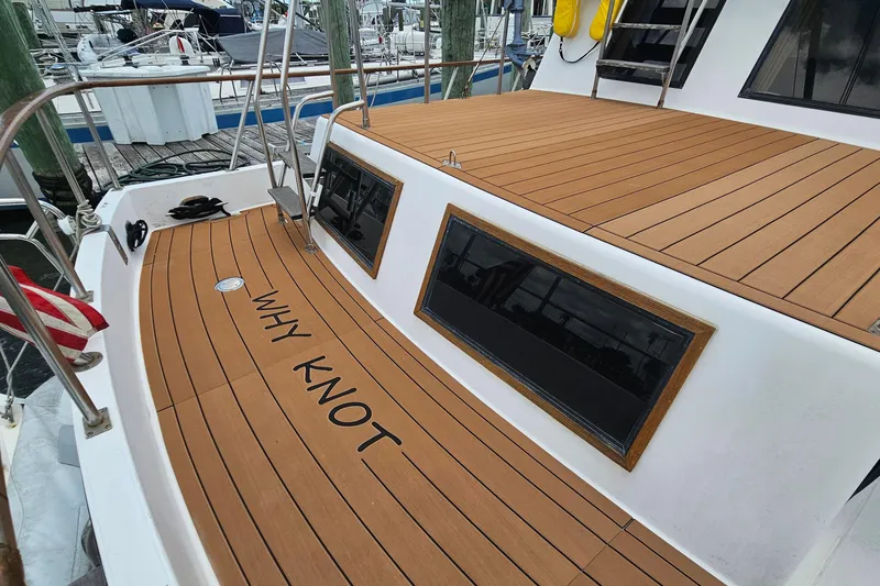 Slide: The Image of Engine of a 1988 Overseas Monk 42 boat, showing wear and connected hoses. - 93