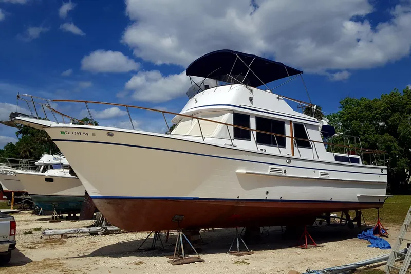 Slide: The Image of 1988 Overseas Monk 42 yacht on land, under a clear blue sky. - 106