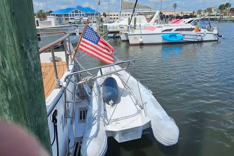 Slide: The Image of Docked 1988 Overseas Monk 42 boat with American flag in marina. - 11