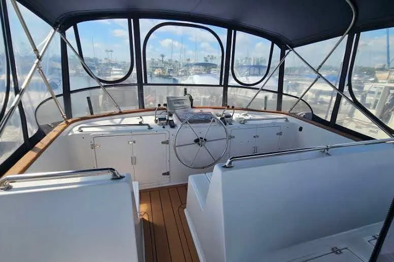 Slide: The Image of Helm of 1988 Overseas Monk 42 yacht with wooden deck and panoramic windows. - 12