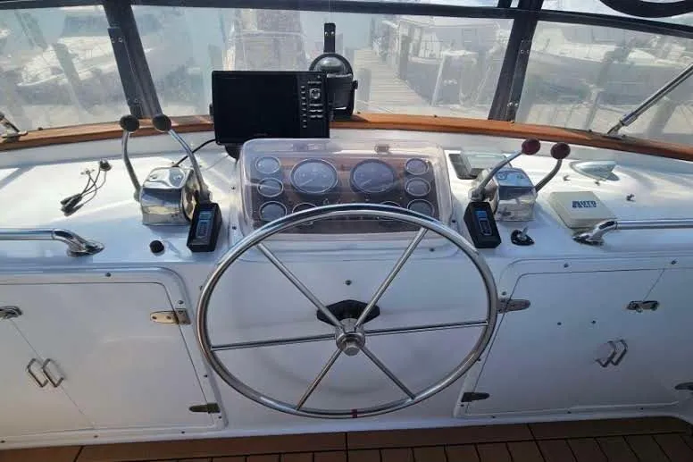 Slide: The Image of Helm of 1988 Overseas Monk 42 yacht with steering wheel and navigation instruments. - 13
