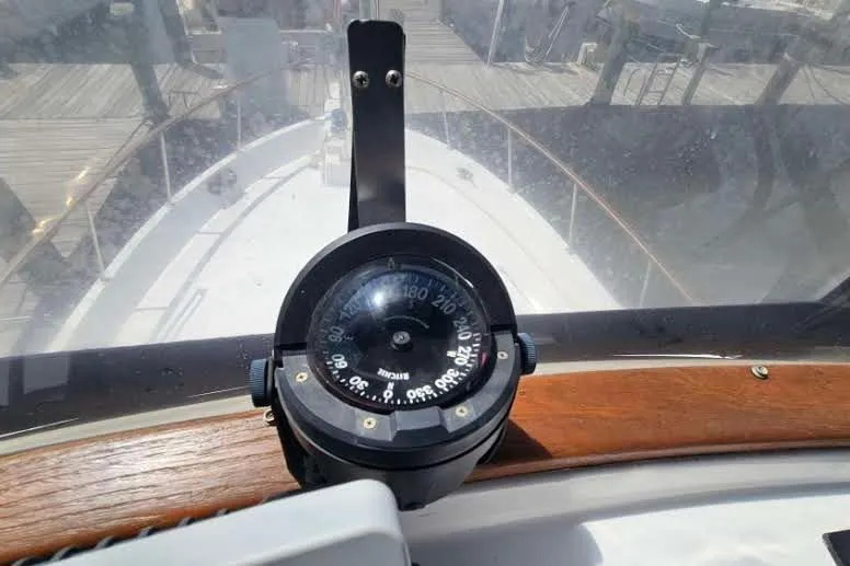 Slide: The Image of Compass on 1988 Overseas Monk 42 boat, wooden dashboard, docked at marina. - 21