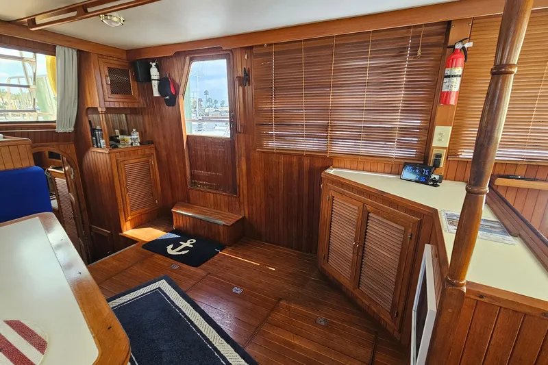 Slide: The Image of Interior of 1988 Overseas Monk 42 yacht with wooden paneling and nautical decor. - 26