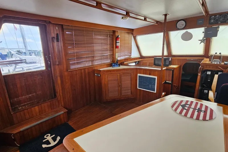 Slide: The Image of Interior of 1988 Overseas Monk 42 yacht with wooden paneling and nautical decor. - 28