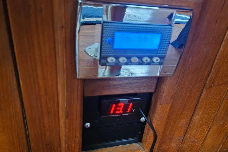 Slide: The Image of Digital display panel on 1988 Overseas Monk 42 boat, showing voltage and time. - 31