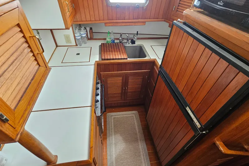 Slide: The Image of Compact wooden kitchen interior of 1988 Overseas Monk 42 boat. - 33