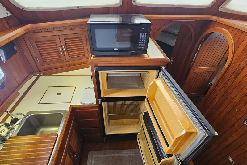 Slide: The Image of Interior of 1988 Overseas Monk 42 yacht kitchen with microwave and open fridge. - 38