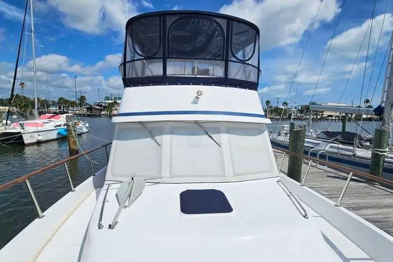 Slide: The Image of 1988 Overseas Monk 42 yacht docked at marina under blue sky. - 4