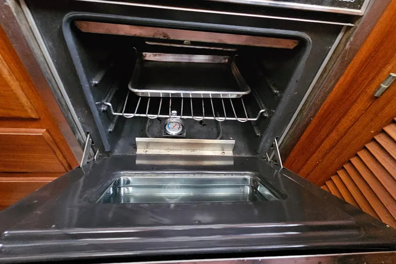Slide: The Image of Open oven door with interior view, featuring a tray and thermometer inside. - 41