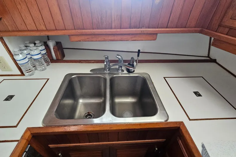 Slide: The Image of 1988 Overseas Monk 42 kitchen sink with dual basins and wooden cabinetry. - 44