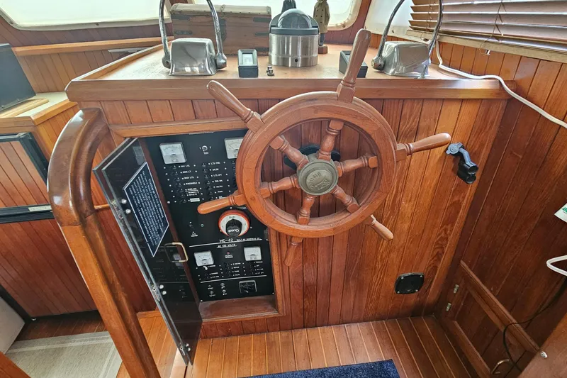Slide: The Image of Wooden helm station of 1988 Overseas Monk 42 boat with control panel. - 48