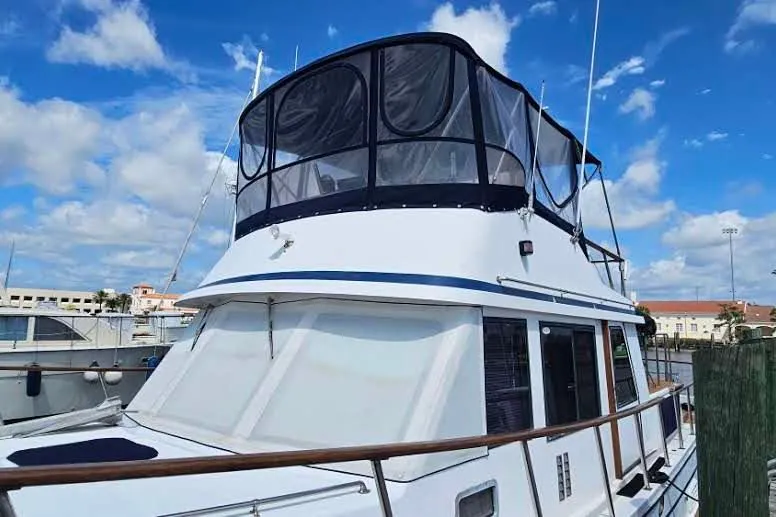 Slide: The Image of 1988 Overseas Monk 42 yacht docked under a clear blue sky. - 5