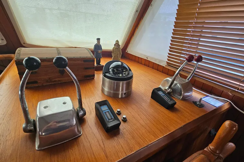 Slide: The Image of Control panel of a 1988 Overseas Monk 42 boat with levers and nautical instruments. - 52
