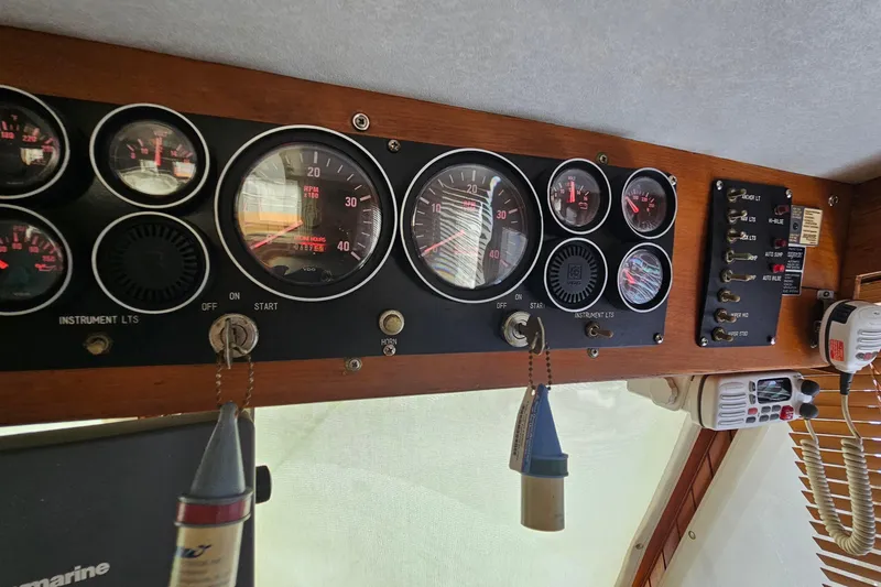 Slide: The Image of Dashboard of a 1988 Overseas Monk 42 boat with gauges and controls. - 53