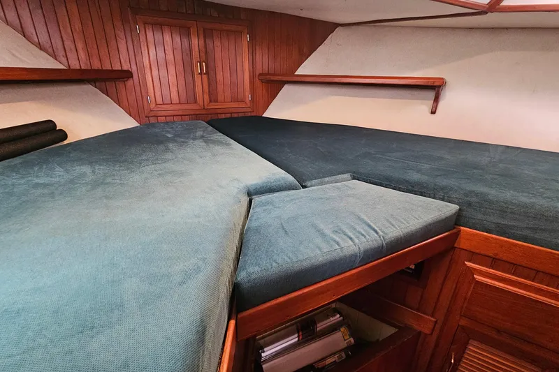 Slide: The Image of Cozy cabin interior of 1988 Overseas Monk 42 yacht with wooden accents and blue cushions. - 60