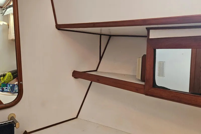 Slide: The Image of Interior of 1988 Overseas Monk 42 boat with wooden shelves and mirror. - 67