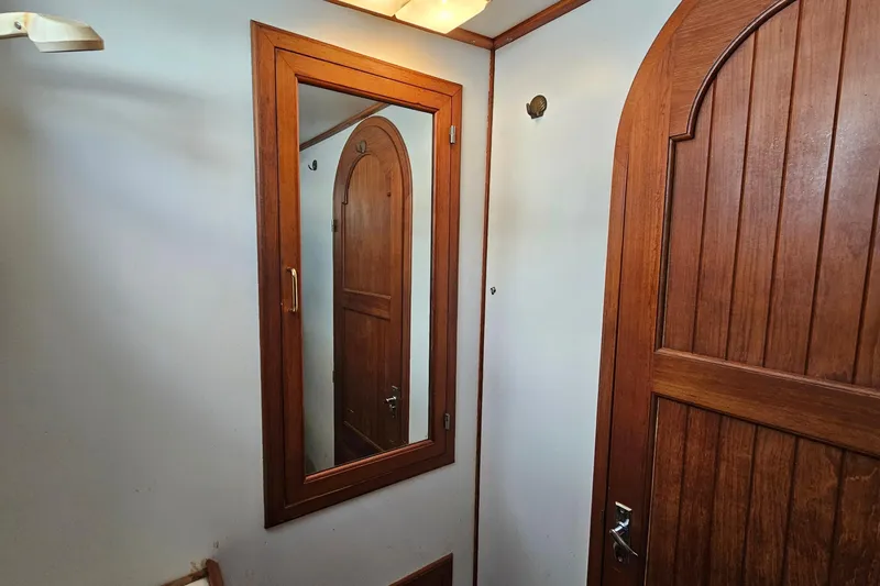 Slide: The Image of Wooden interior of 1988 Overseas Monk 42 yacht with mirror and door. - 68