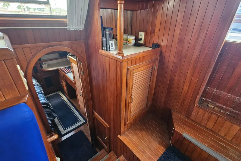 Slide: The Image of Interior of 1988 Overseas Monk 42 yacht with wooden paneling and cozy cabin space. - 74