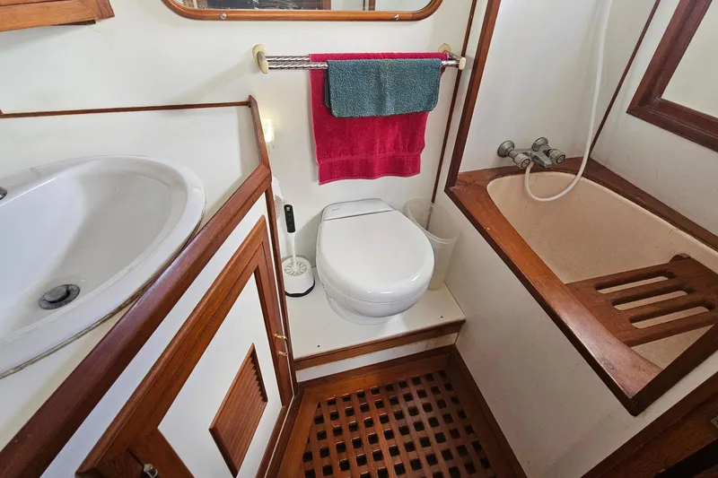 Slide: The Image of Bathroom interior of 1988 Overseas Monk 42 yacht with sink, toilet, and shower. - 85
