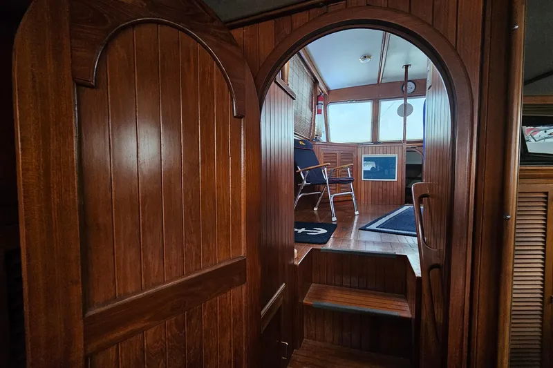 Slide: The Image of Interior of 1988 Overseas Monk 42 yacht with wooden paneling and seating area. - 89