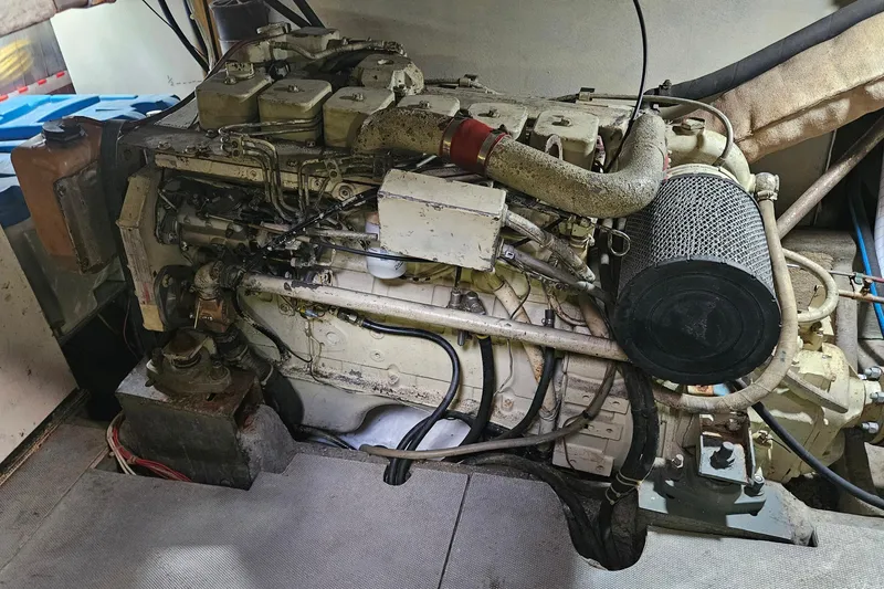 Slide: The Image of Engine of a 1988 Overseas Monk 42 boat, showcasing intricate mechanical components. - 91