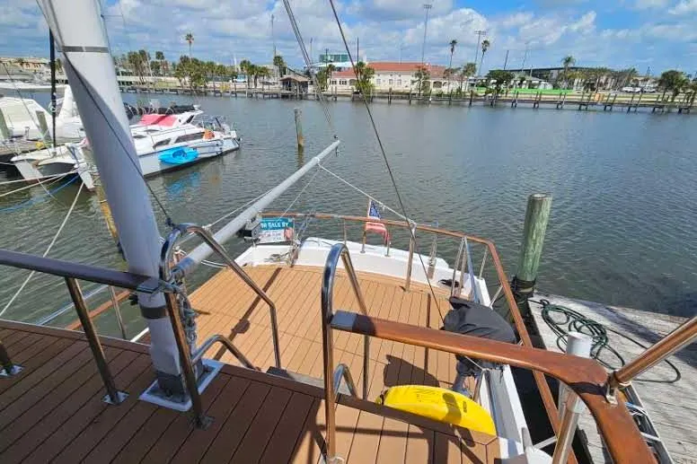 Slide: The Image of 1988 Overseas Monk 42 yacht docked at marina with clear skies. - 96