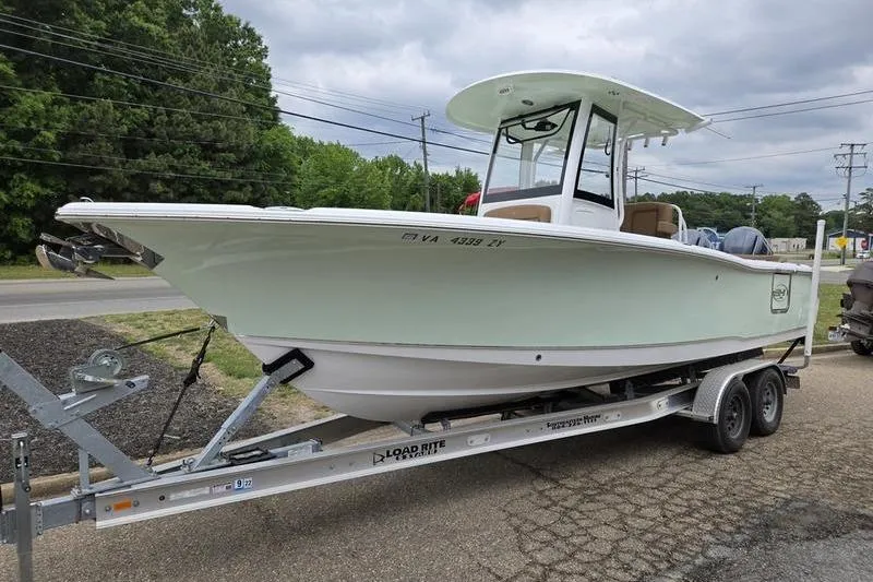 The Image of 2026 Sea Hunt Ultra 265 SE boat on trailer, parked outdoors. - 1