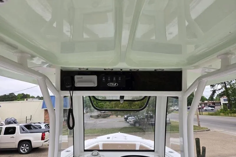 Slide: The Image of 2026 Sea Hunt Ultra 265 SE boat interior, featuring a sleek console and overhead electronics. - 10