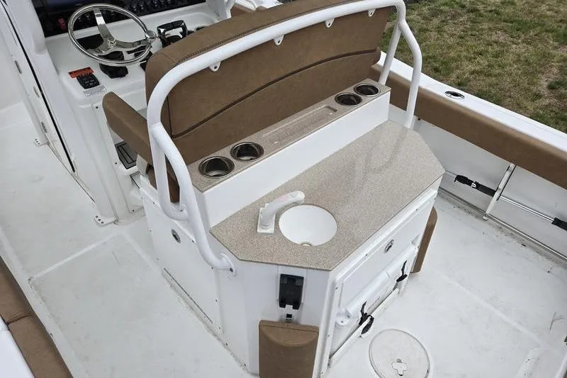 Slide: The Image of 2026 Sea Hunt Ultra 265 SE boat interior with helm, seating, and storage features. - 11