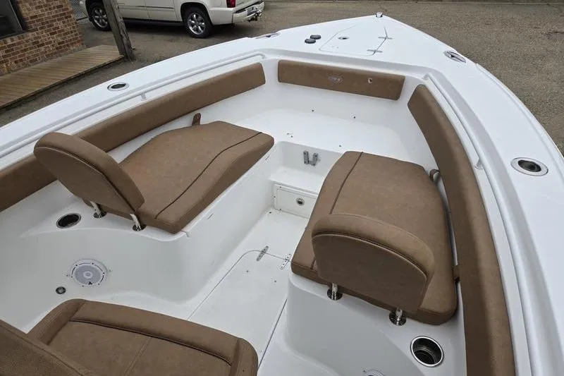 Slide: The Image of 2026 Sea Hunt Ultra 265 SE boat interior with tan seating and white deck. - 12