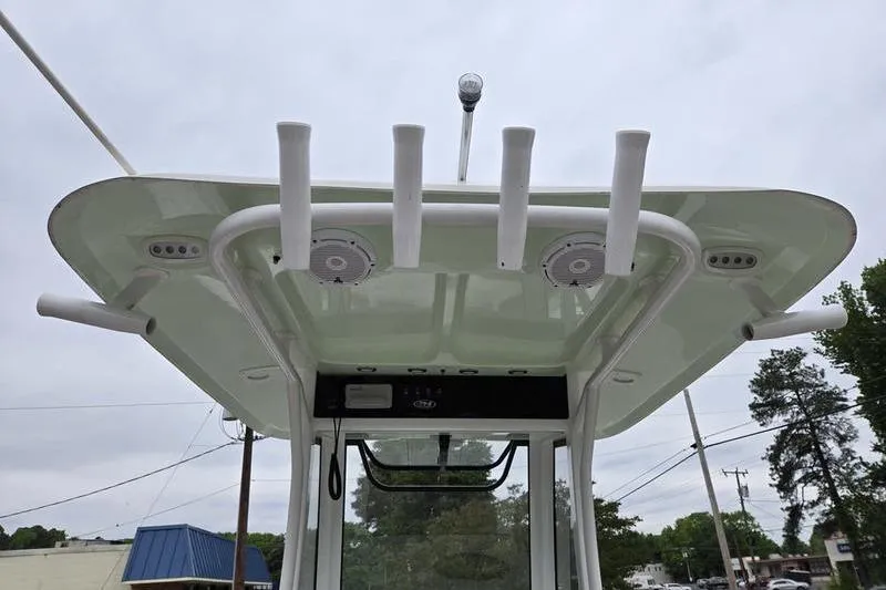 Slide: The Image of 2026 Sea Hunt Ultra 265 SE boat's T-top with rod holders and speakers. - 13