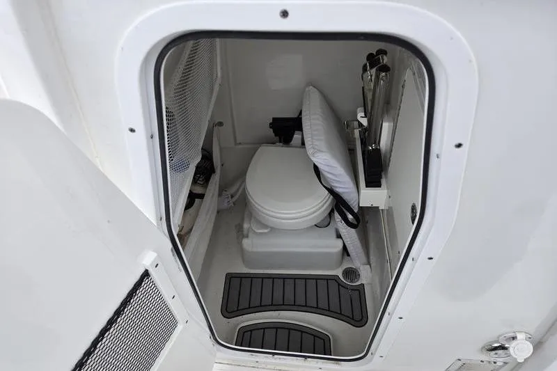 Slide: The Image of Interior view of 2026 Sea Hunt Ultra 265 SE boat's compact bathroom. - 14