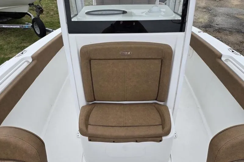 Slide: The Image of 2026 Sea Hunt Ultra 265 SE boat interior with tan seating and white deck. - 18