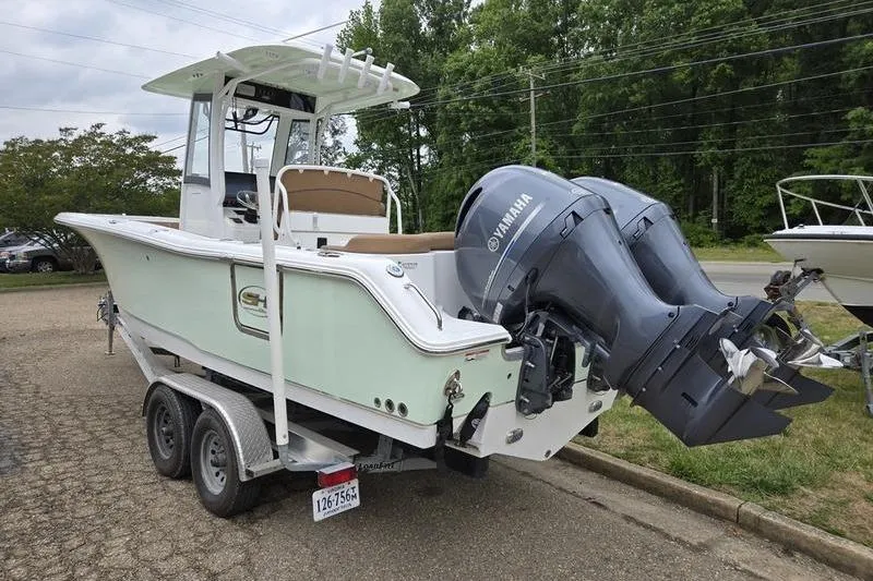 Slide: The Image of 2026 Sea Hunt Ultra 265 SE boat on trailer with dual Yamaha engines. - 5