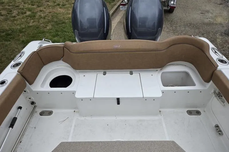 Slide: The Image of 2026 Sea Hunt Ultra 265 SE boat interior with dual engines and cushioned seating. - 6