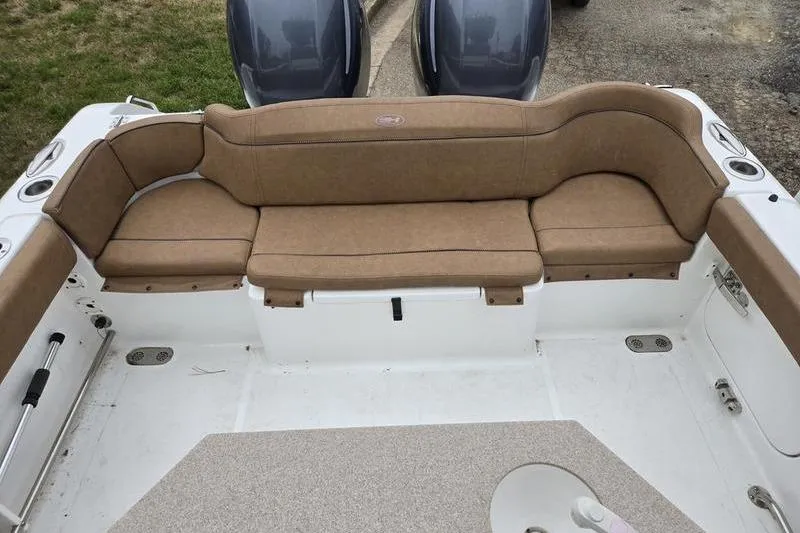 Slide: The Image of 2026 Sea Hunt Ultra 265 SE boat interior with tan seating and dual engines. - 9