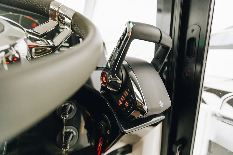 Slide: The Image of Close-up of 2026 Beneteau Antares 11 Fly steering wheel and throttle controls. - 10