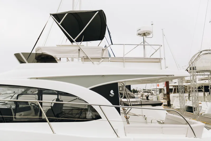 Slide: The Image of 2026 Beneteau Antares 11 Fly yacht docked at marina, showcasing sleek design and flybridge. - 3