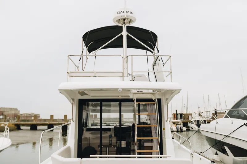 Slide: The Image of 2026 Beneteau Antares 11 Fly yacht, rear view, docked in marina. - 4