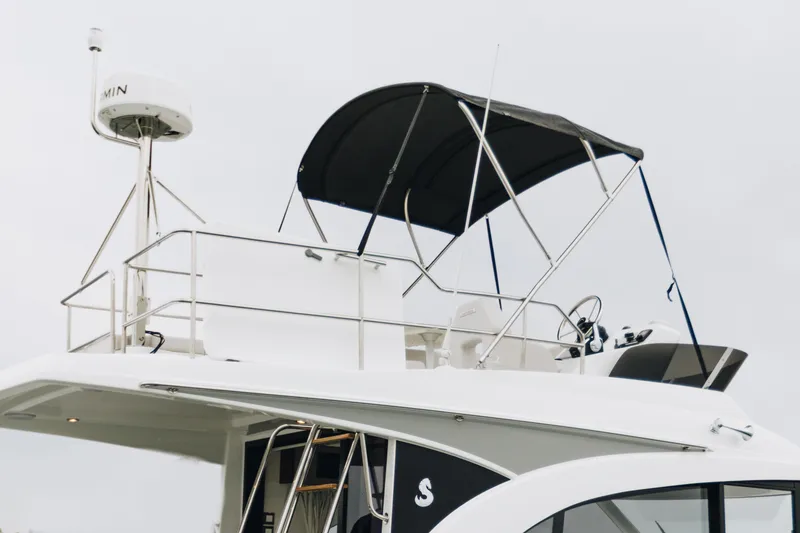 Slide: The Image of 2026 Beneteau Antares 11 Flybridge with radar and canopy, side view. - 6