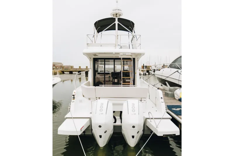 Slide: The Image of 2026 Beneteau Antares 11 Fly yacht with dual outboard engines docked at marina. - 7
