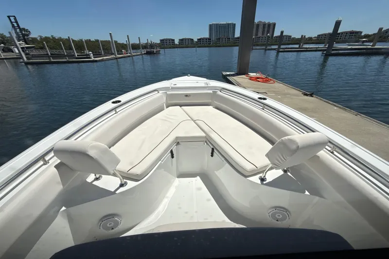 Slide: The Image of 2021 Sea Hunt Ultra 239 SE boat with spacious seating at marina dock. - 14