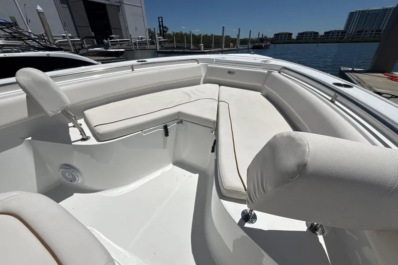 Slide: The Image of 2021 Sea Hunt Ultra 239 SE boat interior with white cushioned seating. - 15